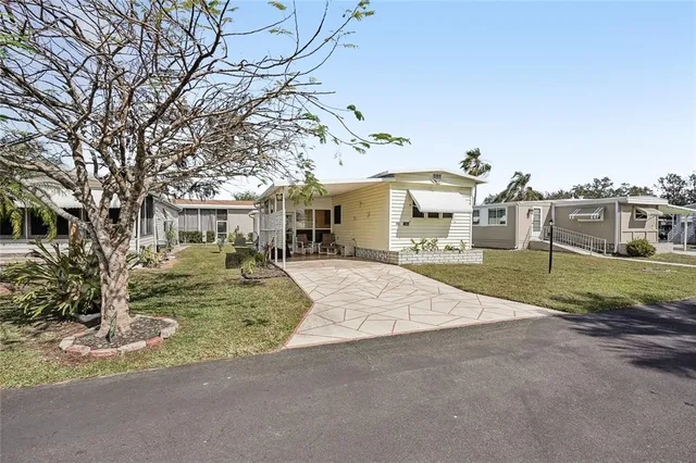 a front view of a house with a yard garage and outdoor seating