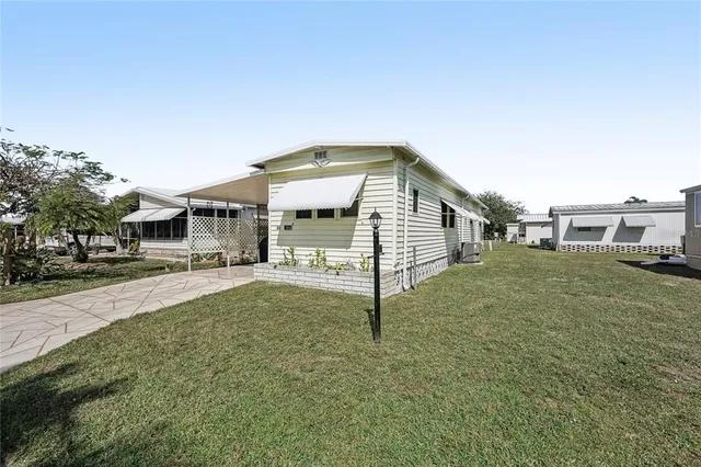 a view of a house with a backyard