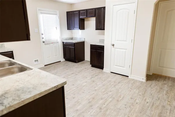 a kitchen with stainless steel appliances granite countertop a sink and a stove