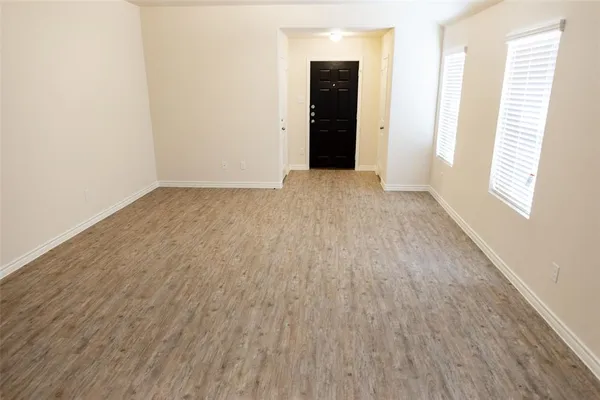 an empty room with windows and entrance