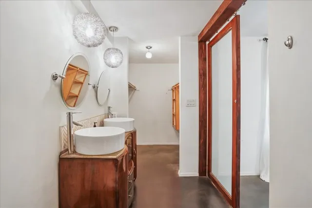 a bathroom with a sink a toilet and a mirror