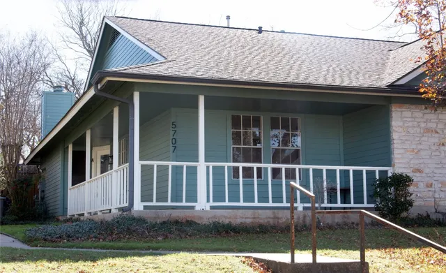 a view of house with a yard