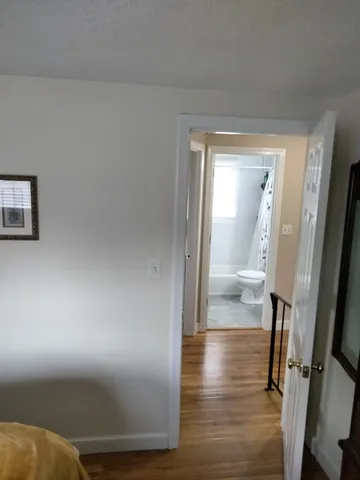 a view of a hallway with wooden floor