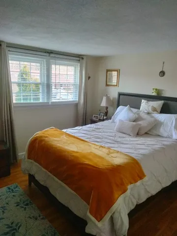 a bed sitting in a bedroom next to a window