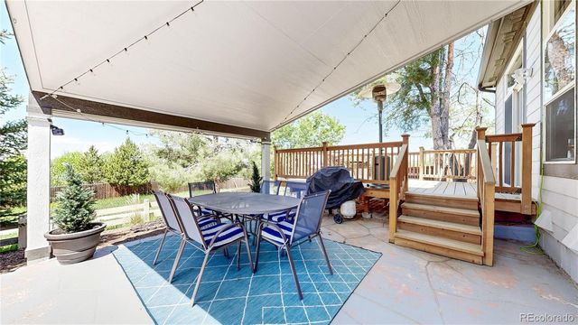 an aerial view of a house with a yard swimming pool and outdoor seating