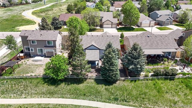 an aerial view of a house with a yard and lake