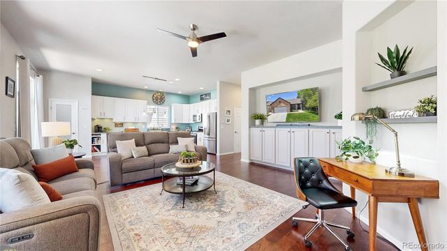 a living room with furniture and a potted plant