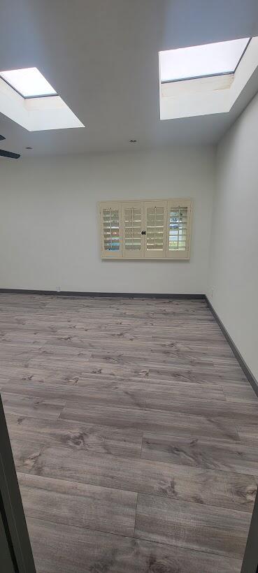 1855 Ramon Road, Unit 24 Palm Springs, CA 92264 - Photo 12 of 18 a view of an empty room with wooden floor and a window