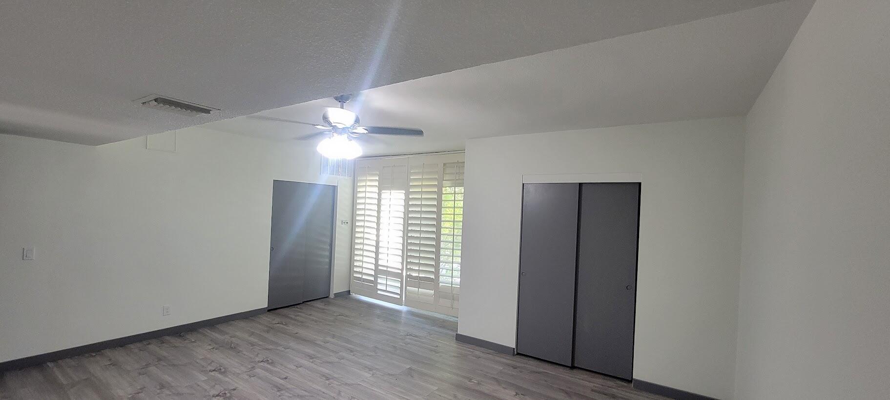 1855 Ramon Road, Unit 24 Palm Springs, CA 92264 - Photo 3 of 18 wooden floor in an empty room with a window