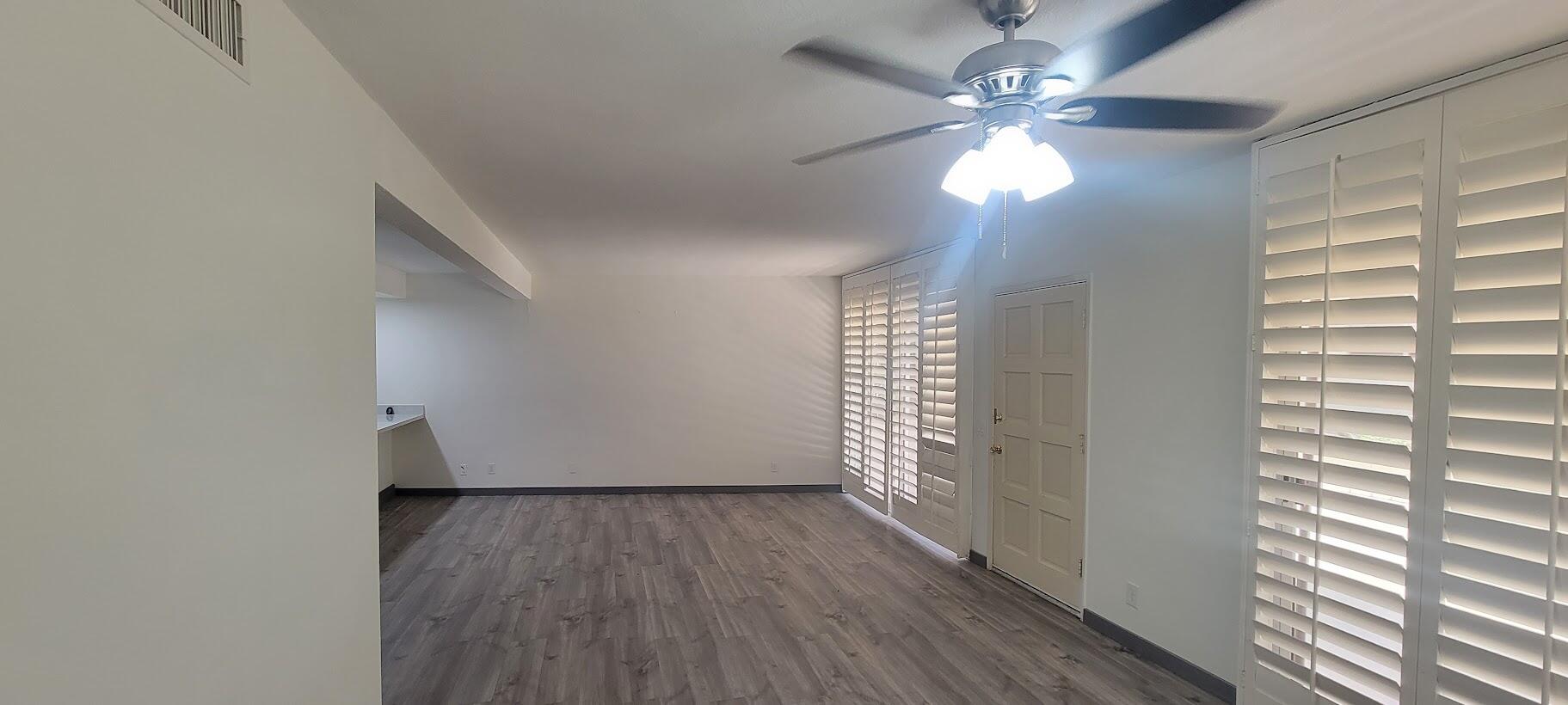 1855 Ramon Road, Unit 24 Palm Springs, CA 92264 - Photo 7 of 18 wooden floor in an empty room with a window