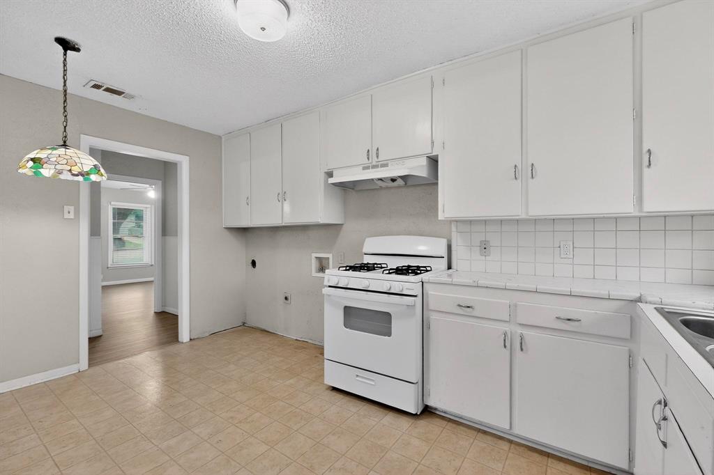 4508 Rutland Avenue Fort Worth, TX 76133 - Photo 13 of 36 a kitchen with white cabinets and white appliances
