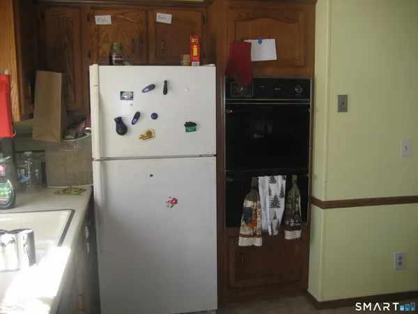 a white refrigerator freezer sitting inside of a kitchen