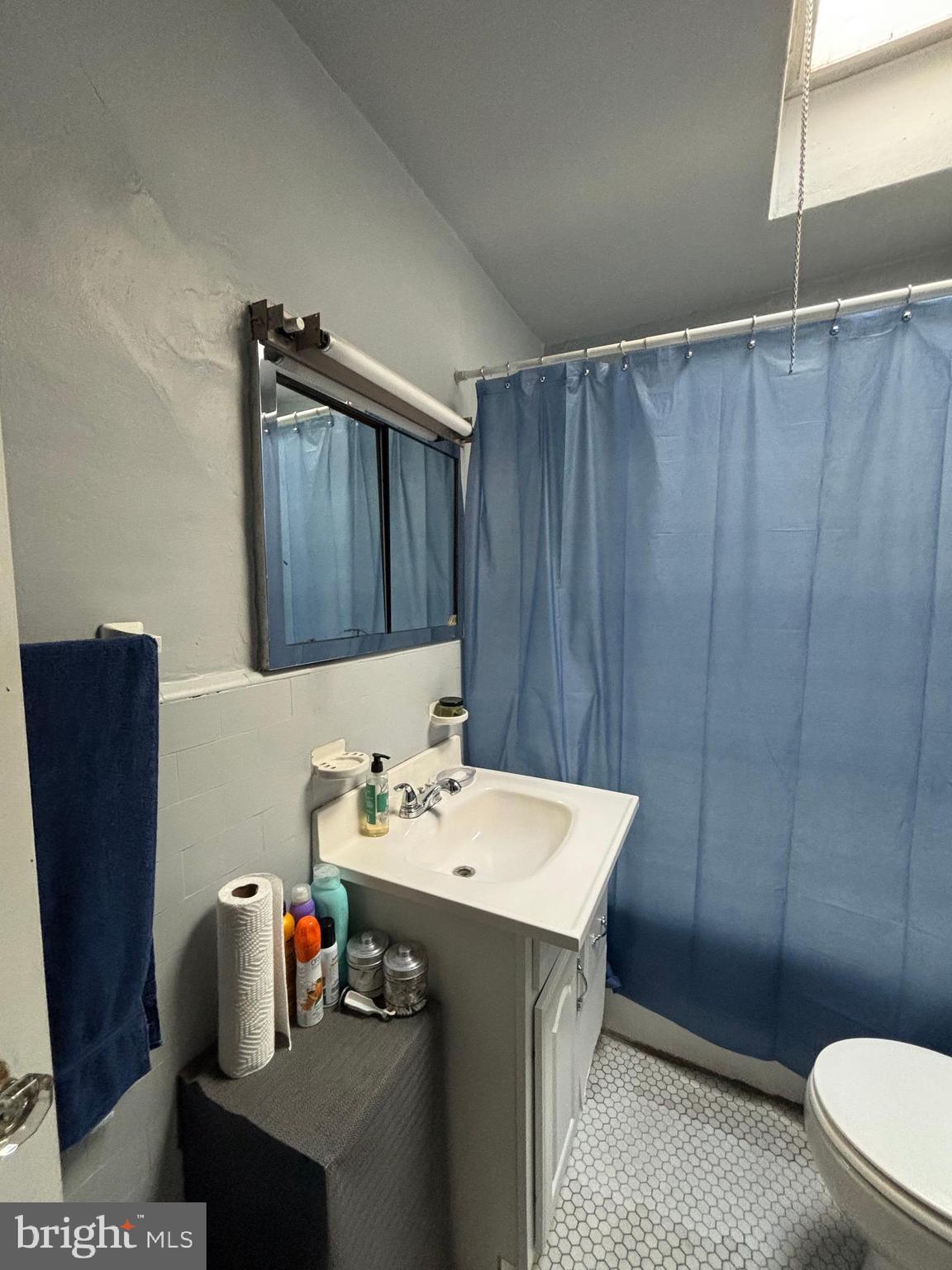 804 Kenmore Road Philadelphia, PA 19151 - Photo 23 of 28 a bathroom with a sink a toilet and vanity