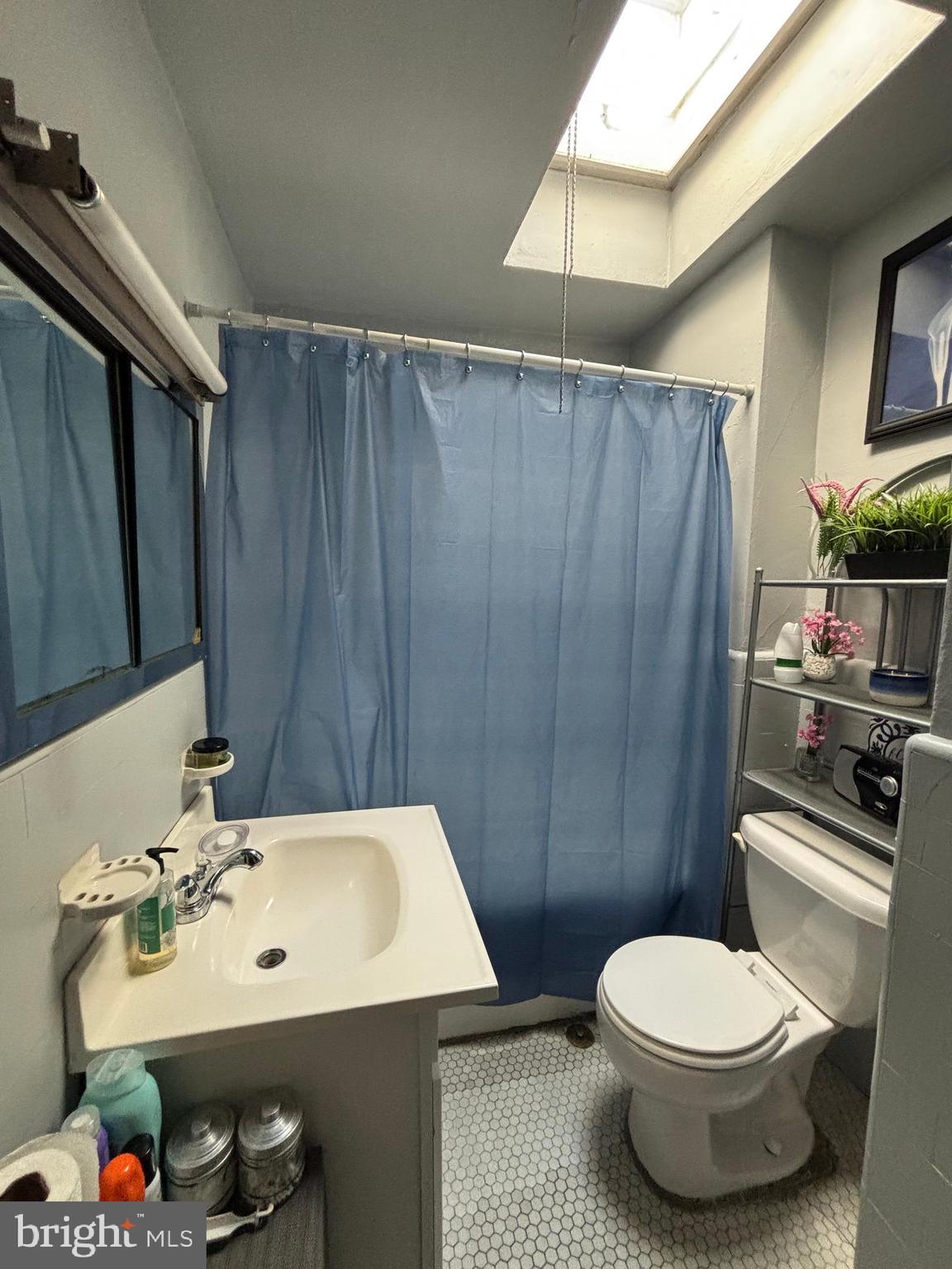 804 Kenmore Road Philadelphia, PA 19151 - Photo 24 of 28 a bathroom with a sink a toilet and a mirror