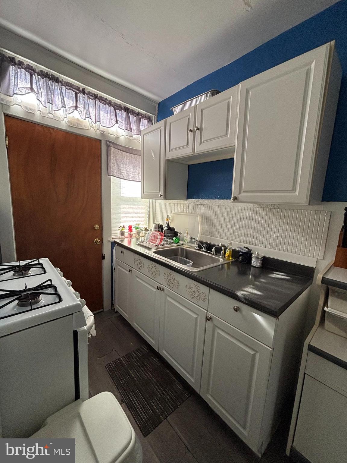 804 Kenmore Road Philadelphia, PA 19151 - Photo 9 of 28 a kitchen with a sink stove and cabinets