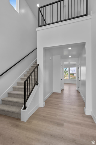 1213 West 500 South Logan, UT 84321 - Photo 2 of 29 Open-concept entry with high ceilings, light wood-finish flooring, and a carpeted staircase featuring black metal railings
