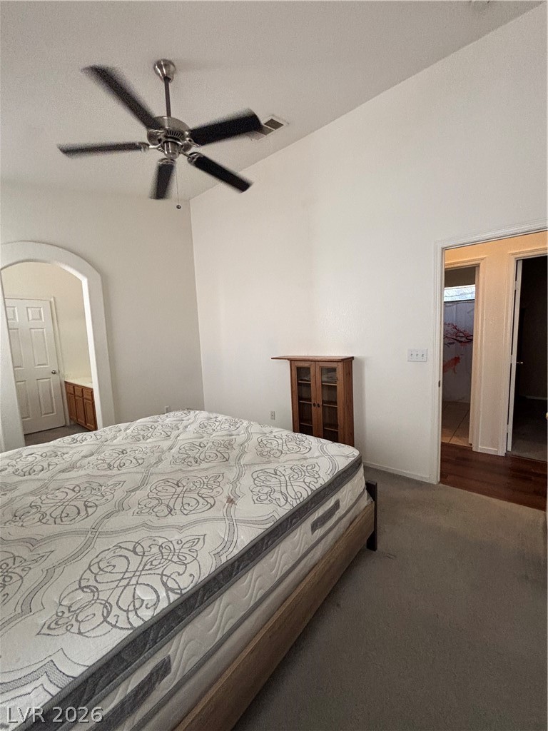2661 Hillgrass Road Las Vegas, NV 89123 - Photo 13 of 27 Bedroom with dark colored carpet, ensuite bath, and ceiling fan
