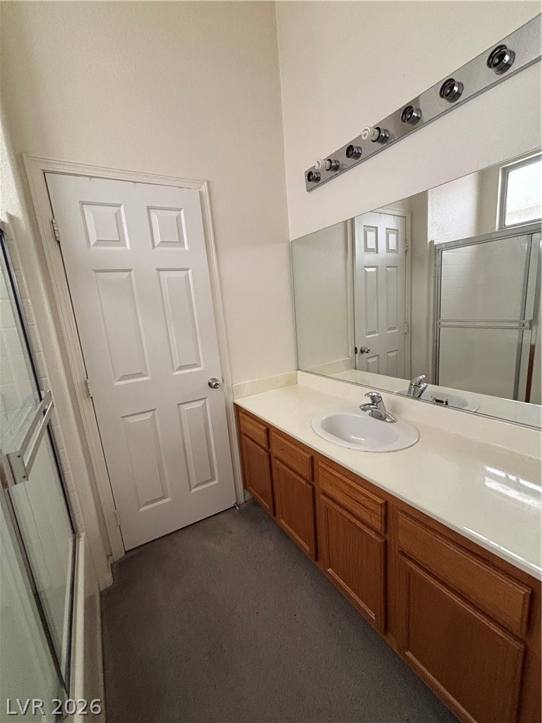 2661 Hillgrass Road Las Vegas, NV 89123 - Photo 15 of 27 Bathroom with a shower with door, vanity, and dark carpet