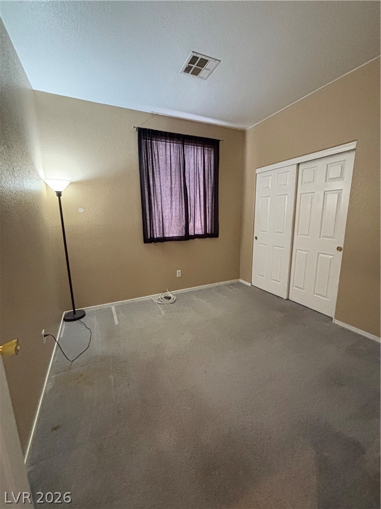 2661 Hillgrass Road Las Vegas, NV 89123 - Photo 17 of 27 Unfurnished bedroom featuring carpet floors and a closet