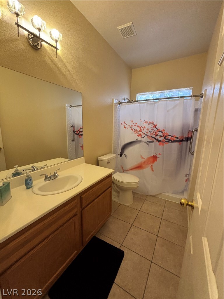 2661 Hillgrass Road Las Vegas, NV 89123 - Photo 18 of 27 Bathroom featuring vanity, light tile patterned flooring, and shower / bathtub combination with curtain