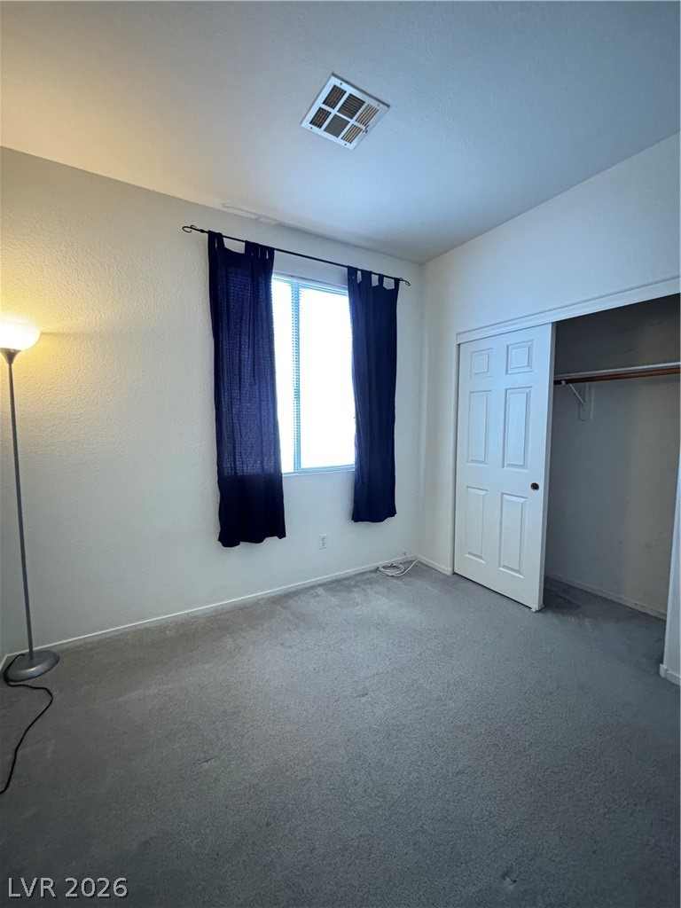 2661 Hillgrass Road Las Vegas, NV 89123 - Photo 21 of 27 Unfurnished bedroom featuring carpet floors and a closet