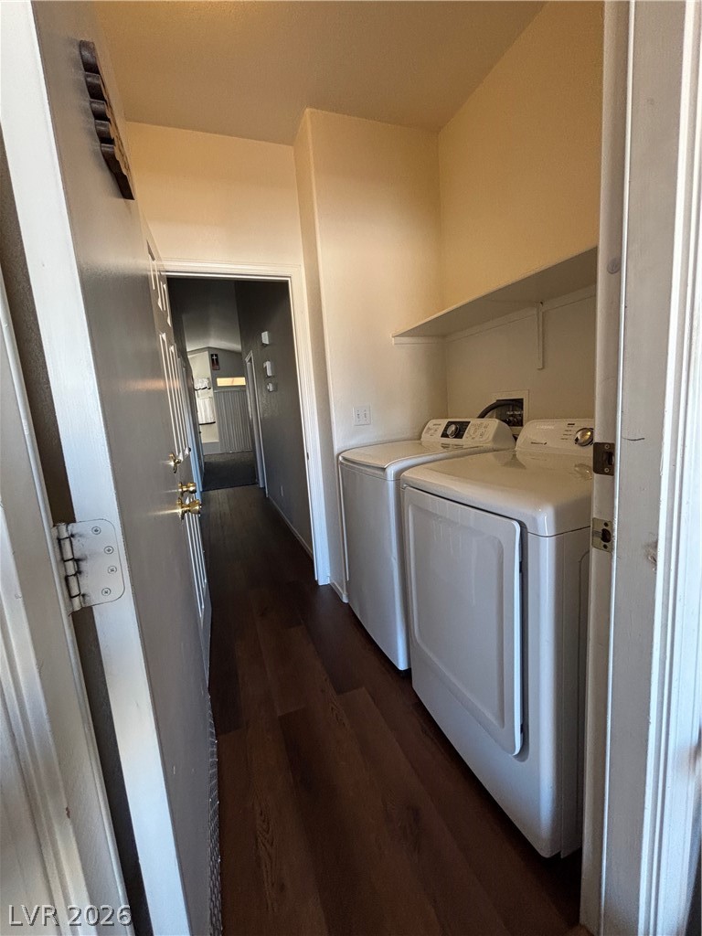 2661 Hillgrass Road Las Vegas, NV 89123 - Photo 22 of 27 Laundry area with dark wood finished floors and washing machine and dryer