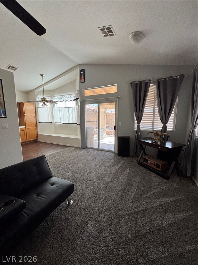 2661 Hillgrass Road Las Vegas, NV 89123 - Photo 4 of 27 Living room featuring ceiling fan, dark colored carpet, and a textured ceiling