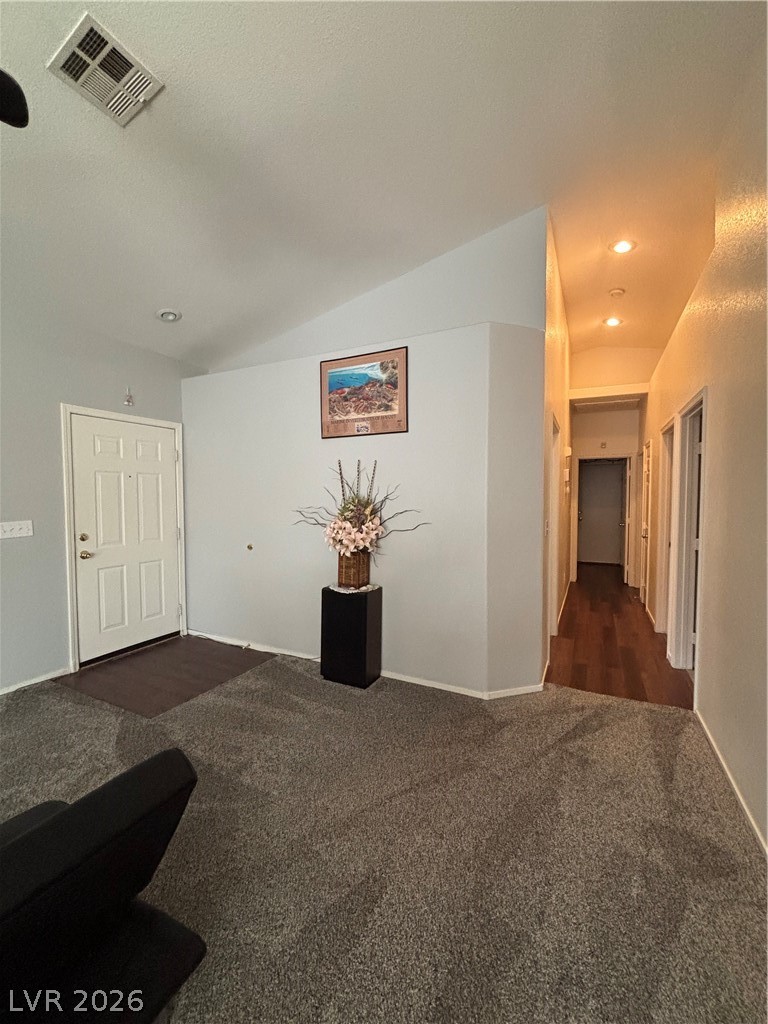 2661 Hillgrass Road Las Vegas, NV 89123 - Photo 8 of 27 Hall with dark colored carpet, recessed lighting, and vaulted ceiling