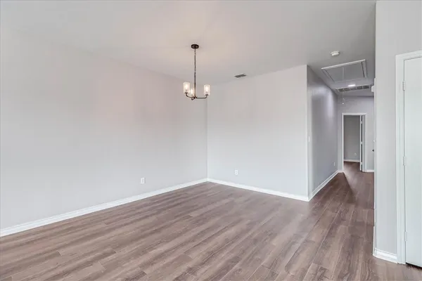a view of a room with wooden floor and a window