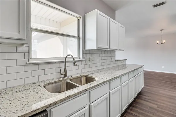 a kitchen with a sink and a window