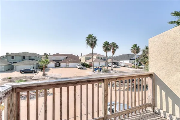 a view of a balcony with wooden floor