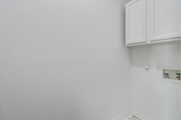 a view of storage and utility room with cabinets