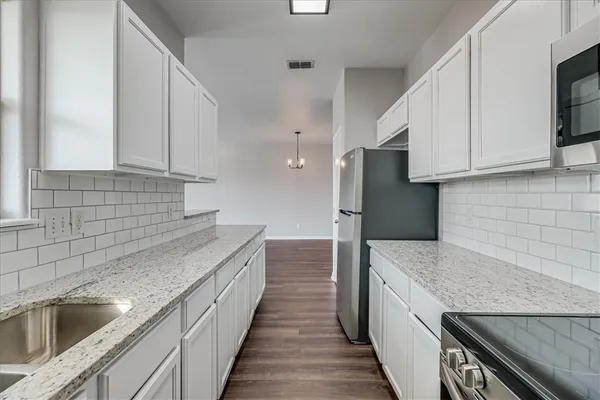a kitchen with a sink and a refrigerator