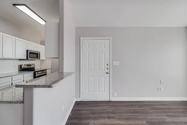 a view of a kitchen with microwave and cabinets