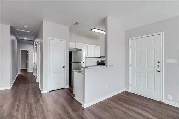 a view of kitchen with furniture and wooden floor