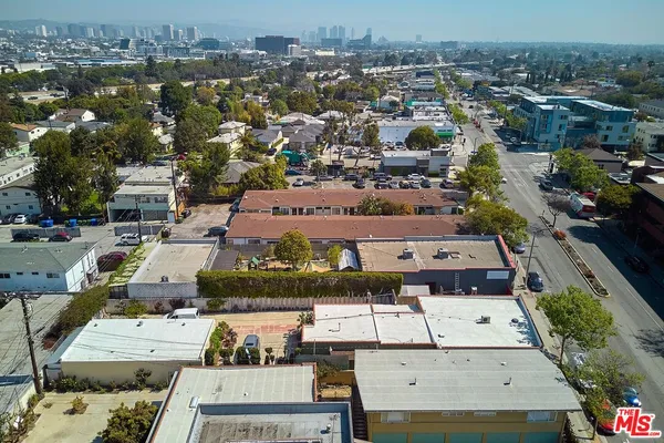 an aerial view of residential houses with outdoor space and parking