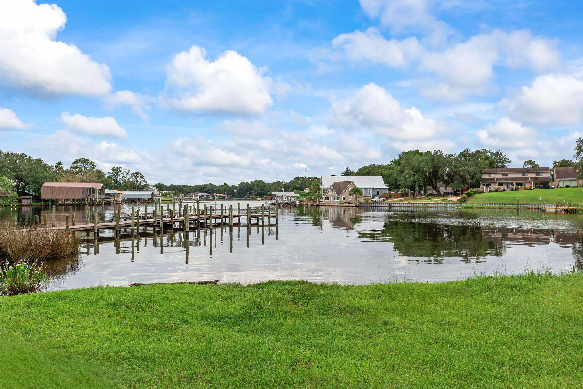 210 Pelham Road, Unit B107 Fort Walton Beach, FL 32547 - Photo 13 of 14 a view of a lake with houses in the back