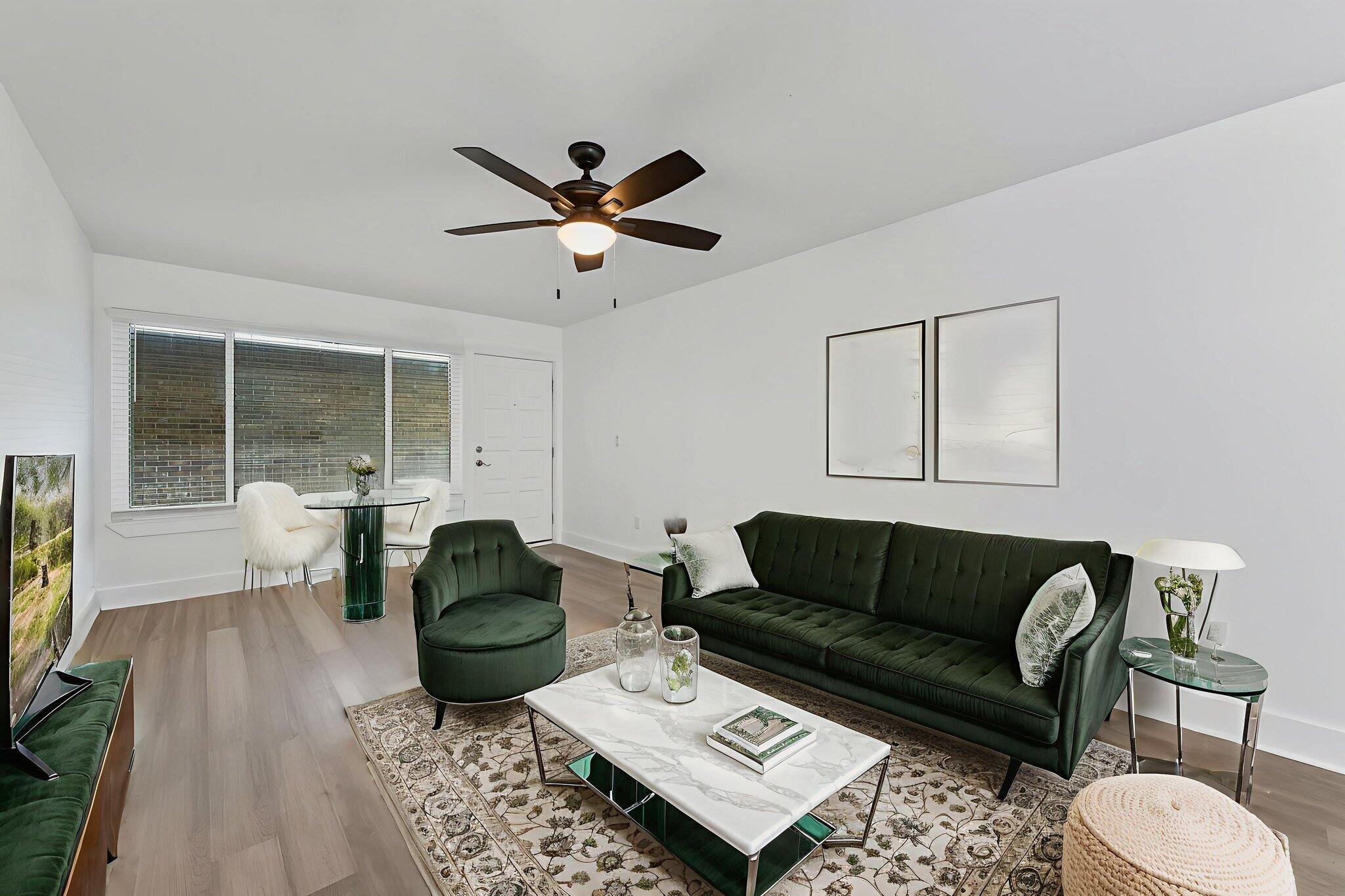 210 Pelham Road, Unit B107 Fort Walton Beach, FL 32547 - Photo 3 of 14 a living room with furniture a ceiling fan and a rug