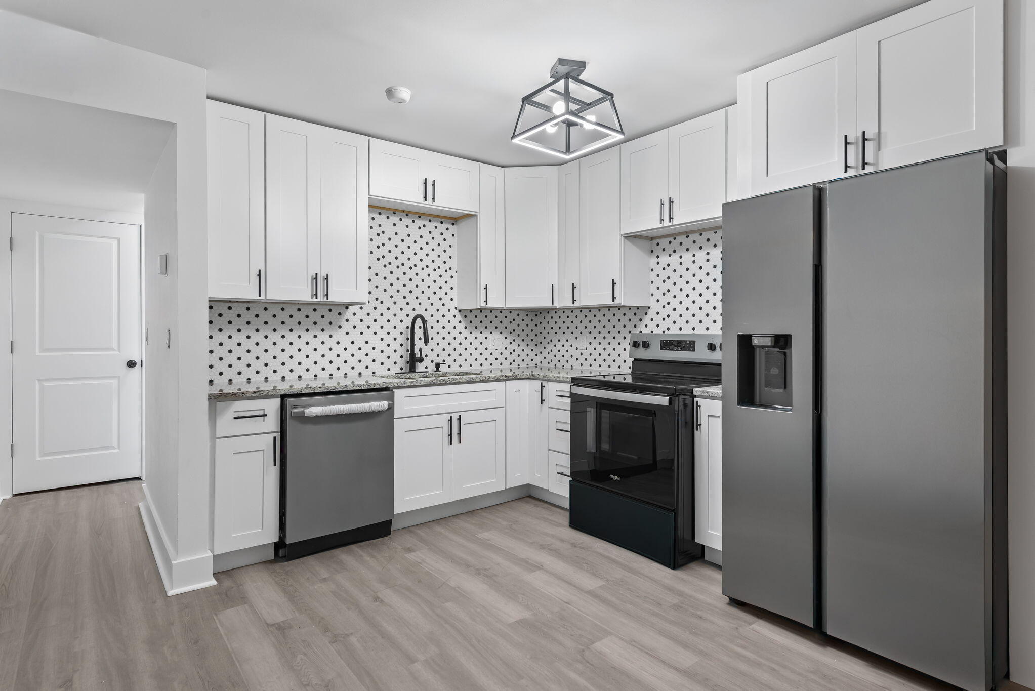 210 Pelham Road, Unit B107 Fort Walton Beach, FL 32547 - Photo 9 of 14 a kitchen with a refrigerator and a sink