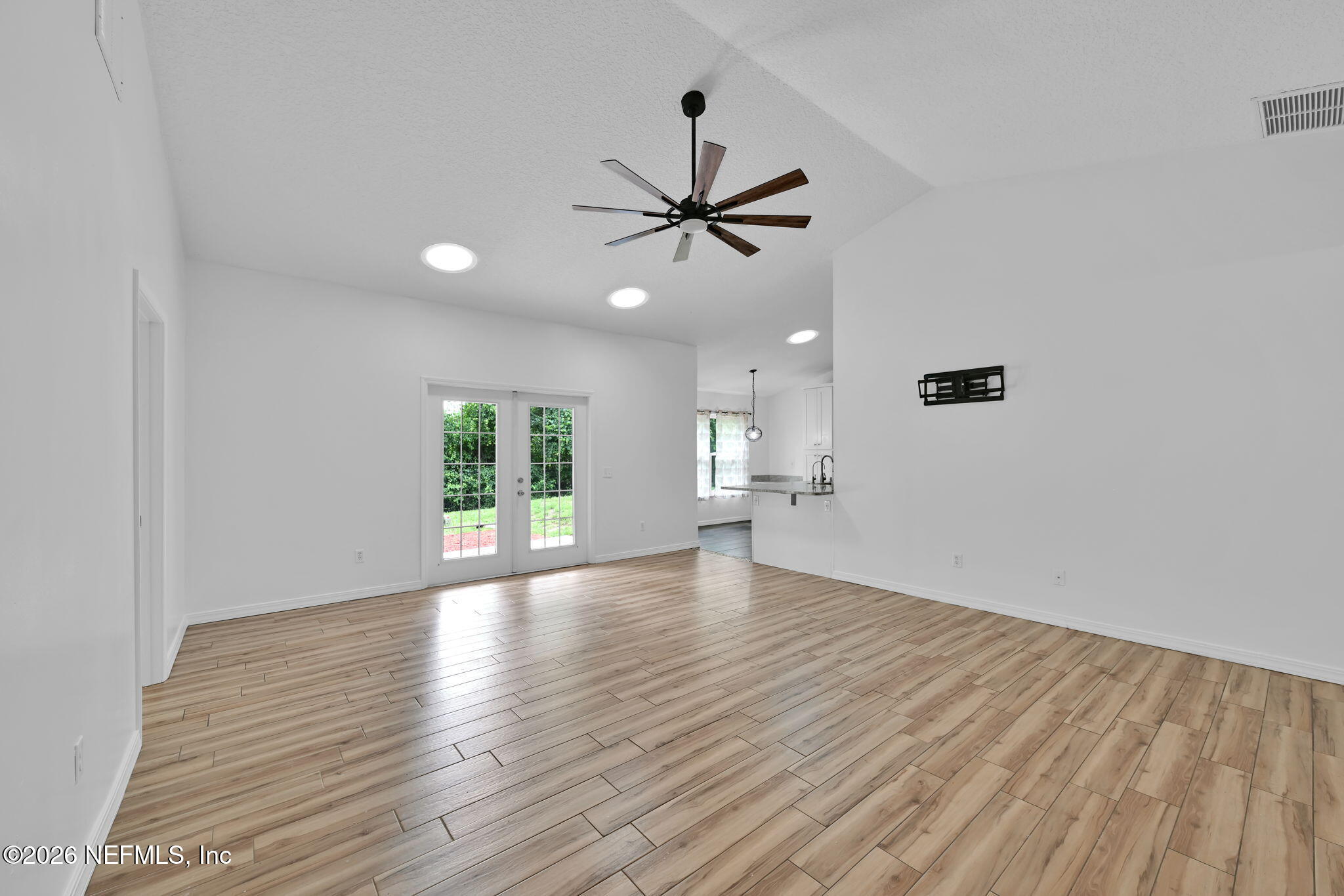 1110 Woodlawn Road, Unit D St. Augustine, FL 32084 - Photo 18 of 40 wooden floor in an empty room with a window