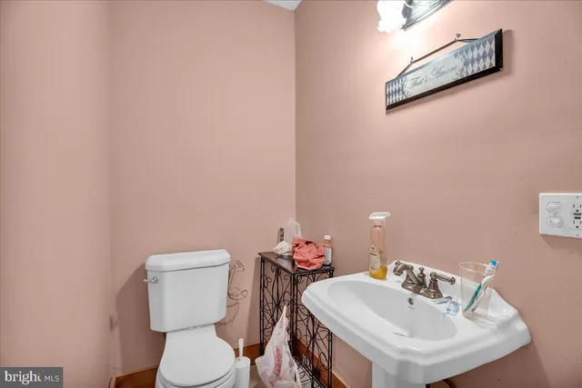 a white toilet sitting next to a bathroom sink