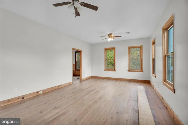 wooden floor in an empty room with a window