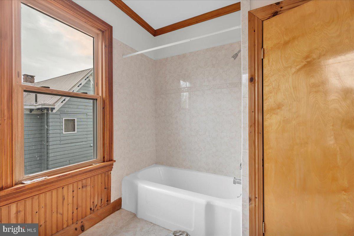 211 South Main Street Elmer, NJ 08318 - Photo 20 of 24 a bathroom with a bathtub and a shower