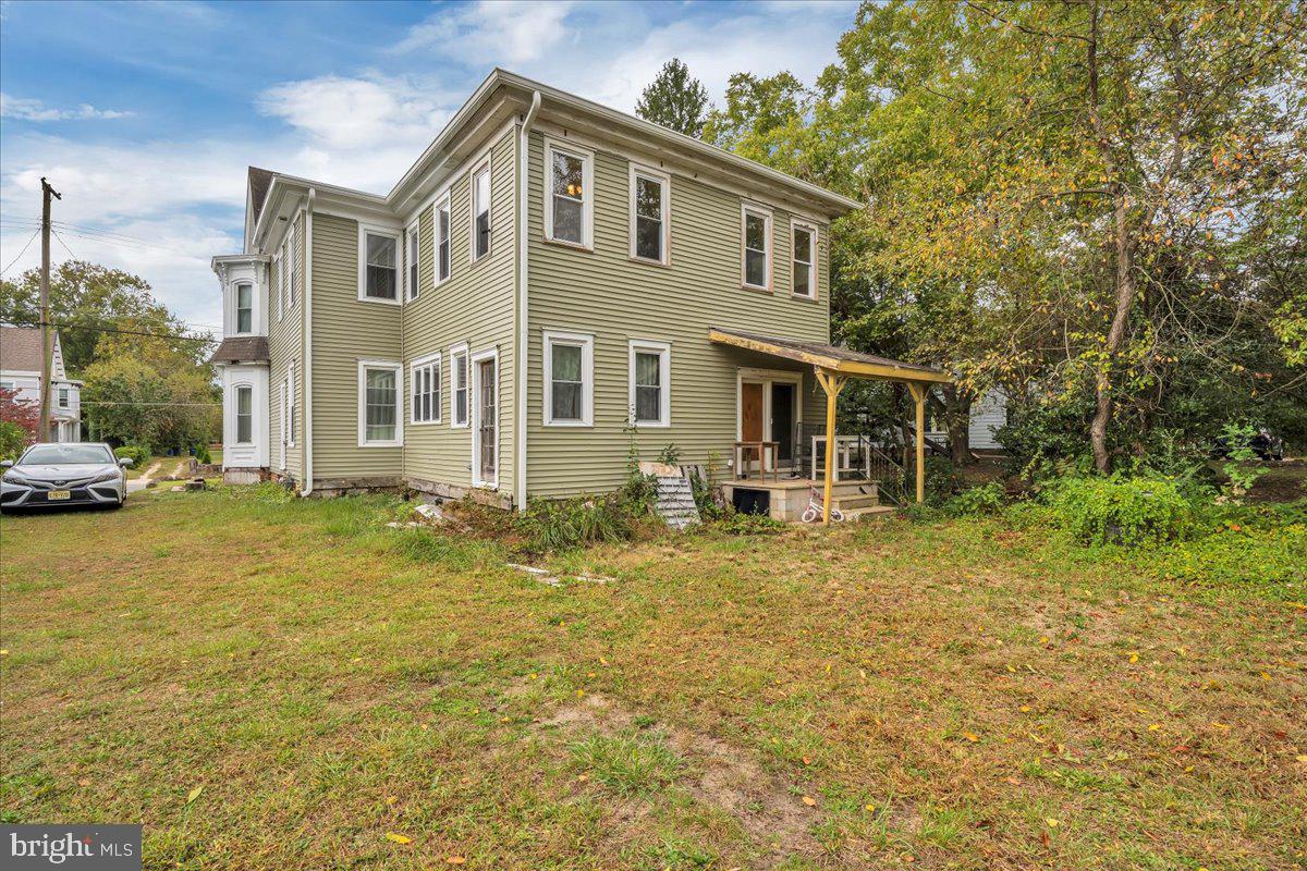 211 South Main Street Elmer, NJ 08318 - Photo 23 of 24 a front view of a house with a garden