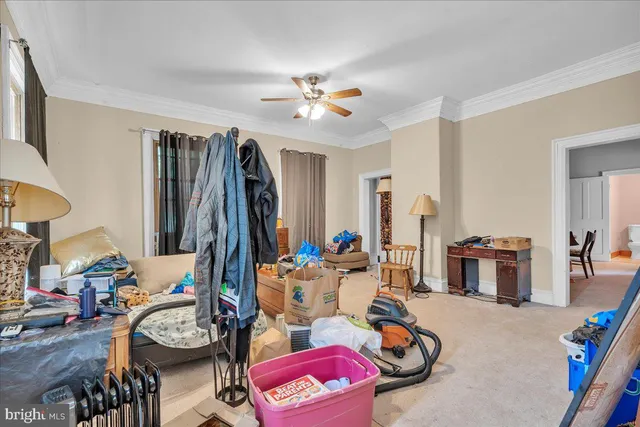 a living room with furniture a flat screen tv and a wall paintings
