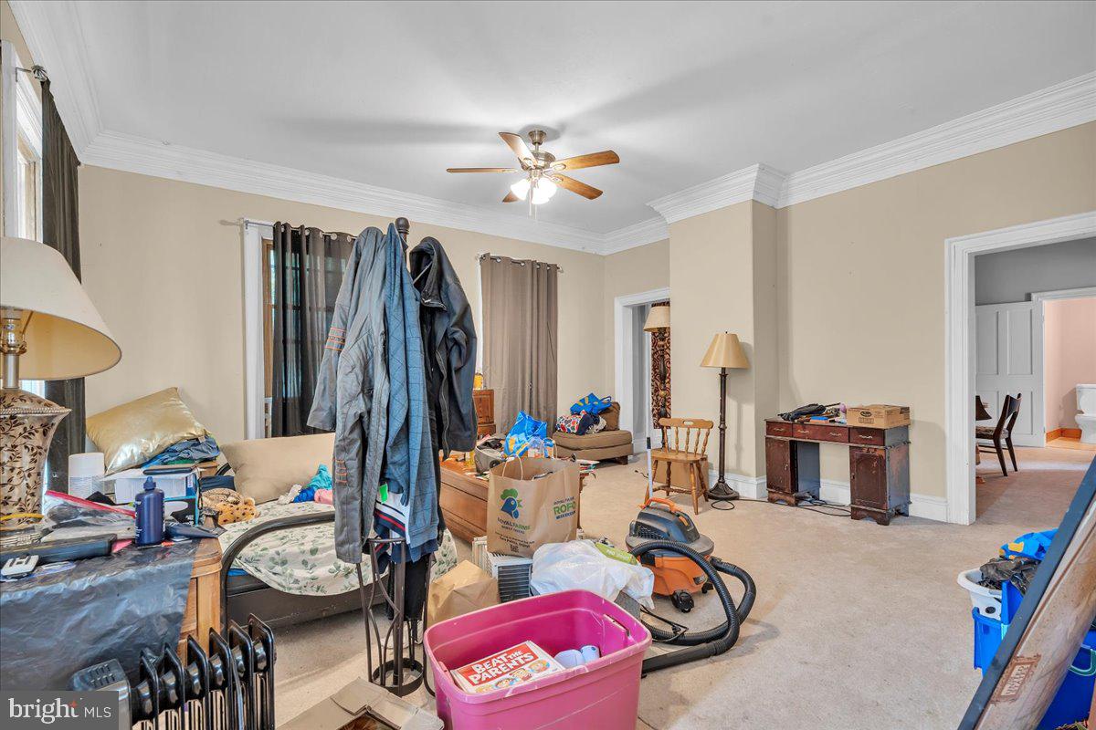 211 South Main Street Elmer, NJ 08318 - Photo 4 of 24 a living room with furniture a flat screen tv and a wall paintings