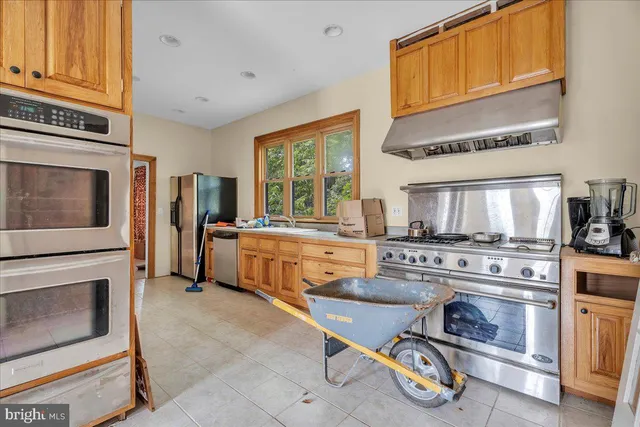 a kitchen with sink stove and cabinets