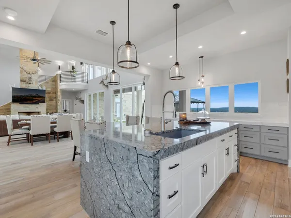 a kitchen with a sink stove and cabinets