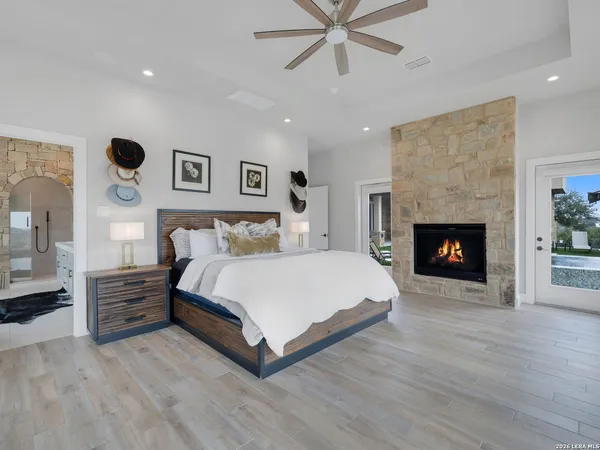 a bedroom with a large bed and a flat tv screen