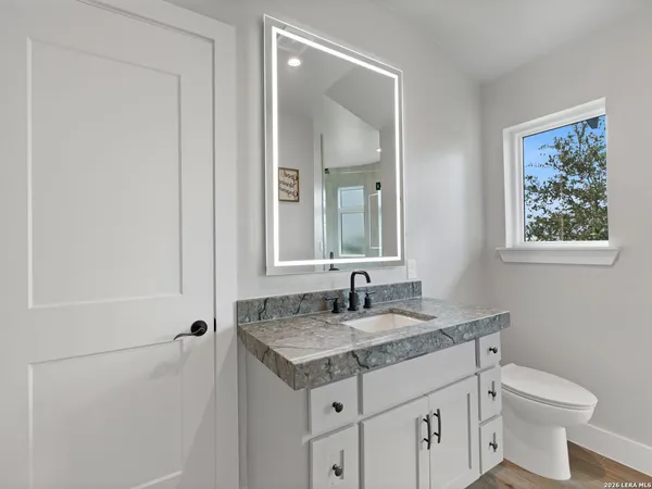 a view of a garden with a bench under an umbrella